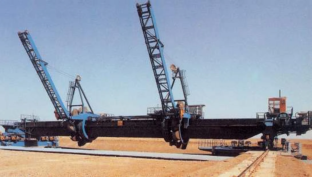 Bridge-type reclaimer with two bucket wheels manufactured by COMSPAIN for storage yards